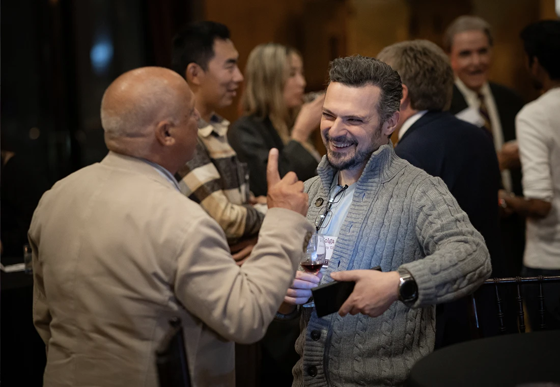 To Knox alumni having a discussion at an reception.