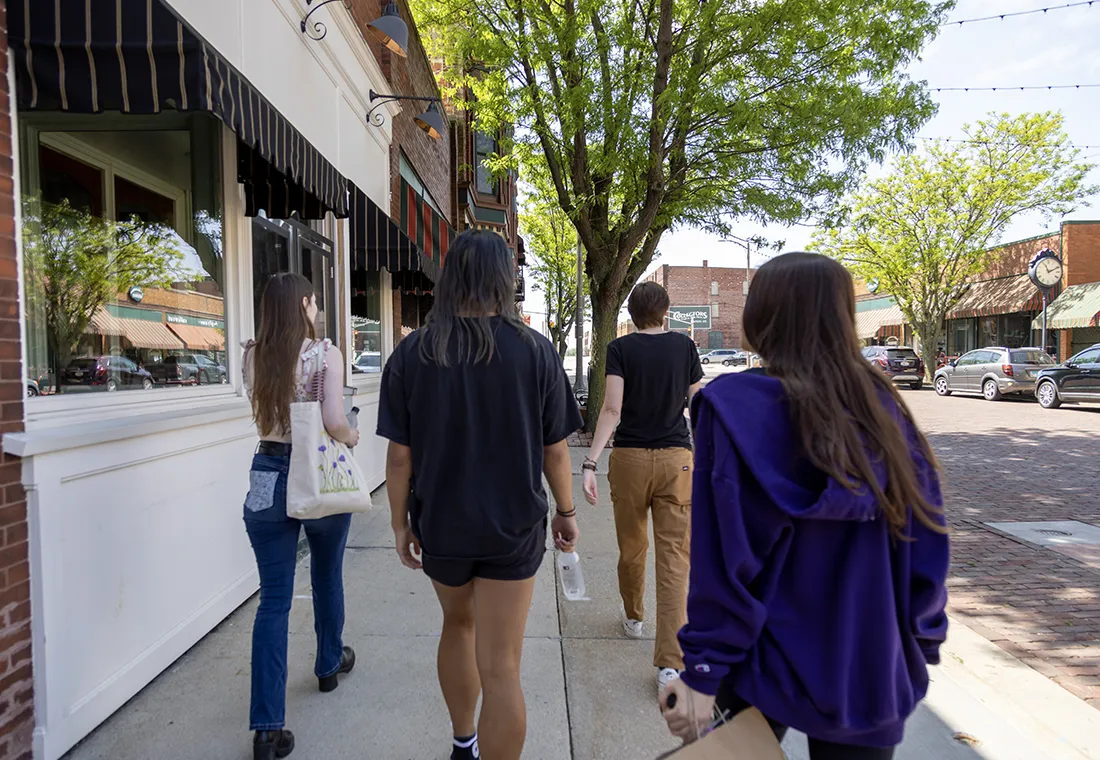 A group of students walk down a street in Galesburg.