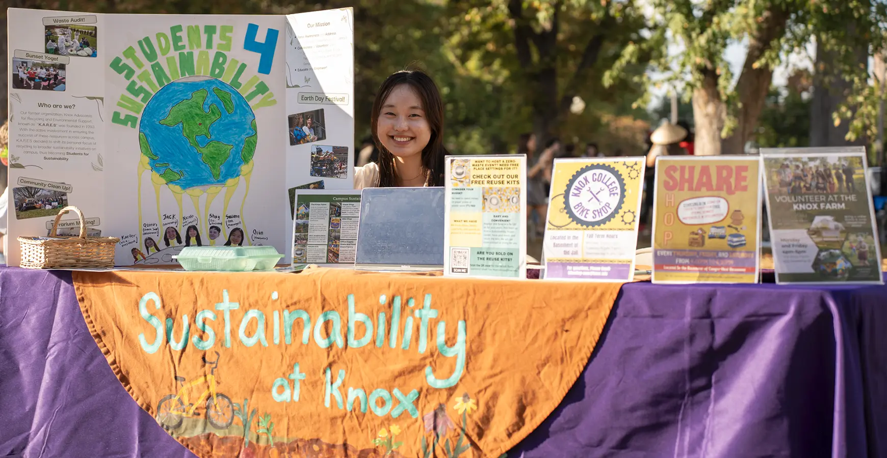 Two students sit at a table with designs for sustainability.