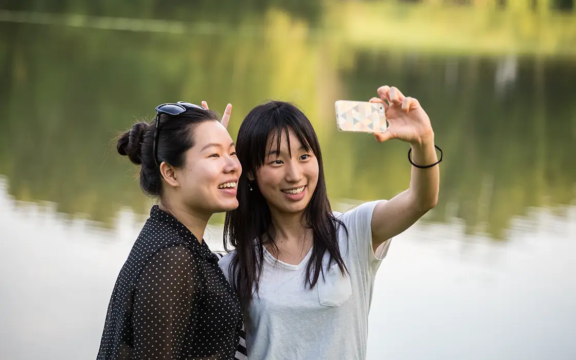 Two Knox students take a selfie by Galesburg's Lake Storey.