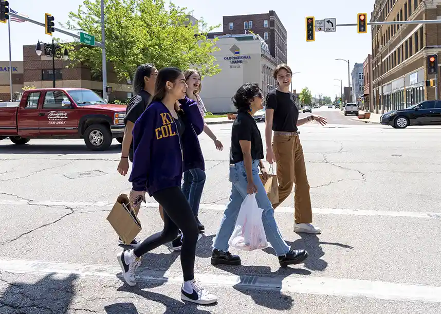 A group of Knox College students cross a street in Downtown Galesburg.