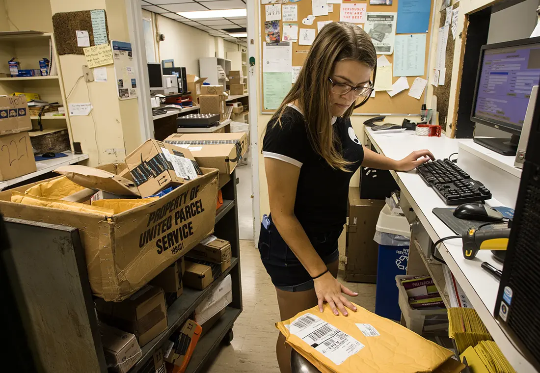 A student works in a mailroom.