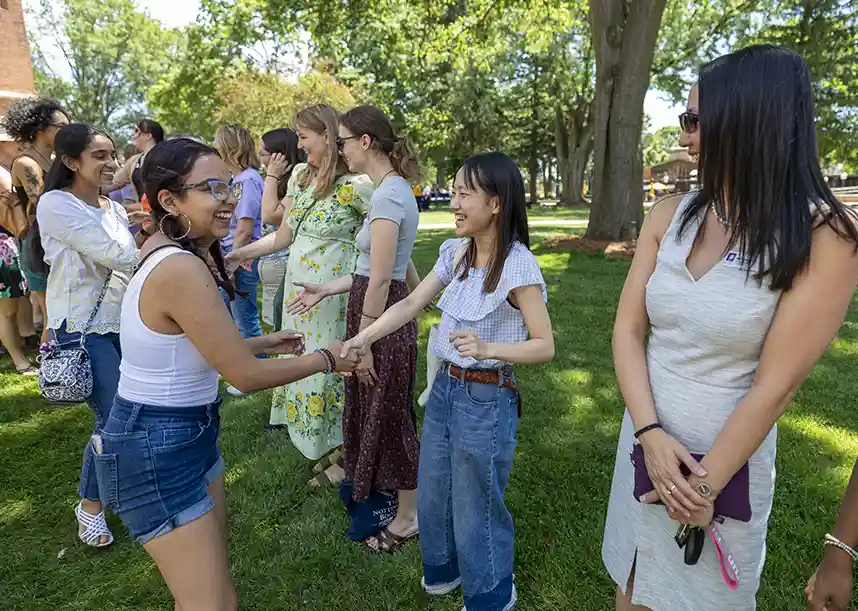 Knox students smile and greet each other with a handshake at the annual tradition Pumphandle.