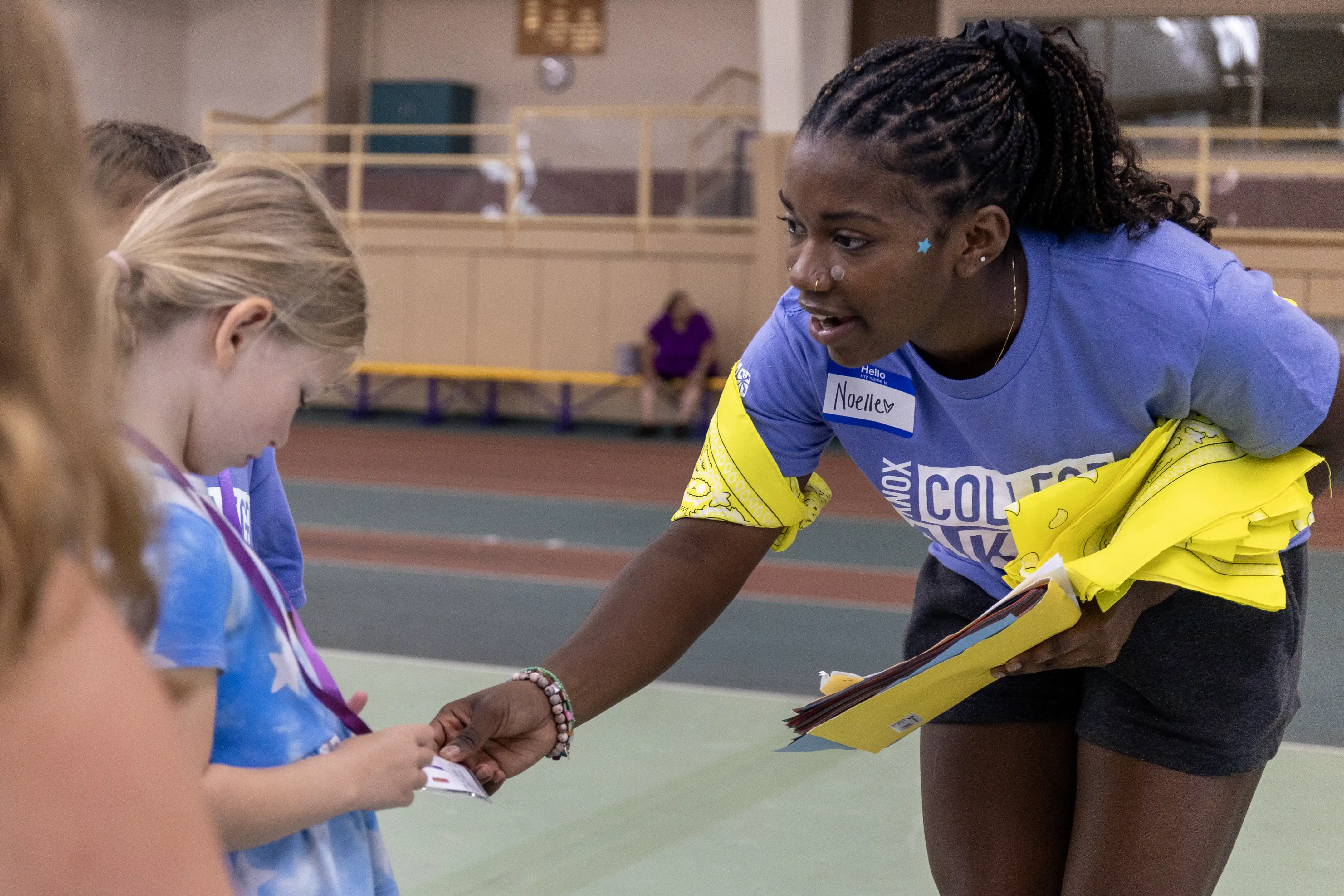 A Knox student bends down to speak to a visiting elementary student.