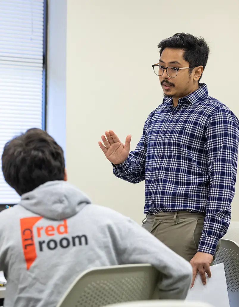 Assistant Professor of Economics Ameesh Upadhyay speaks to students in a classroom. 