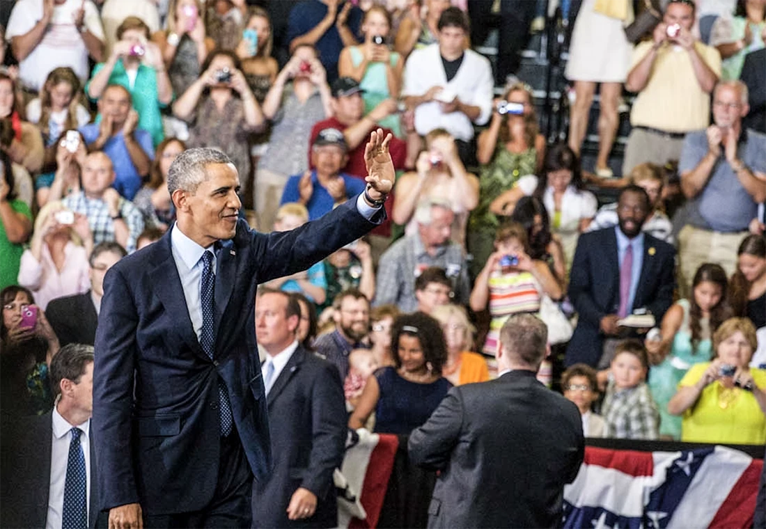 President Obama waves to a crowd of people while visiting Knox College.