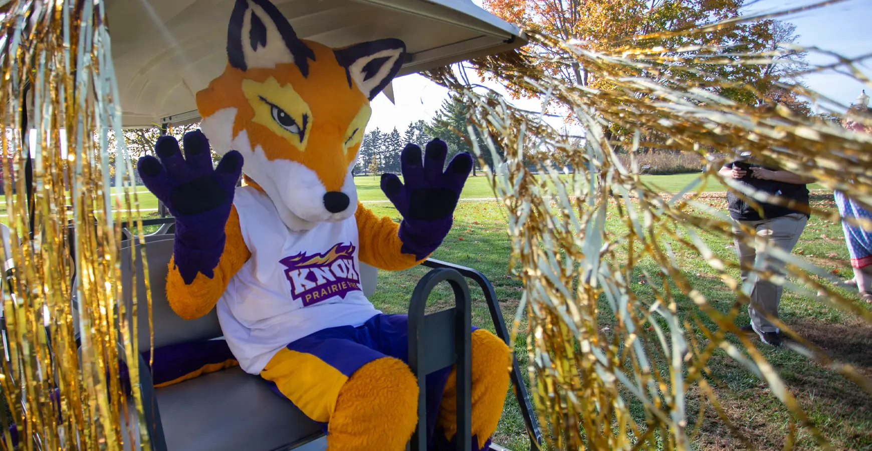 Blaze waves from the back of a golf cart. 
