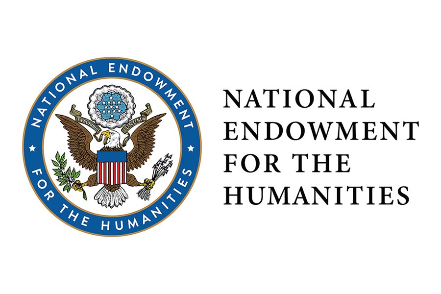 Circular seal, outlined in blue, with an eagle holding a red, white and blue shield. National Endowment for the Humanities.