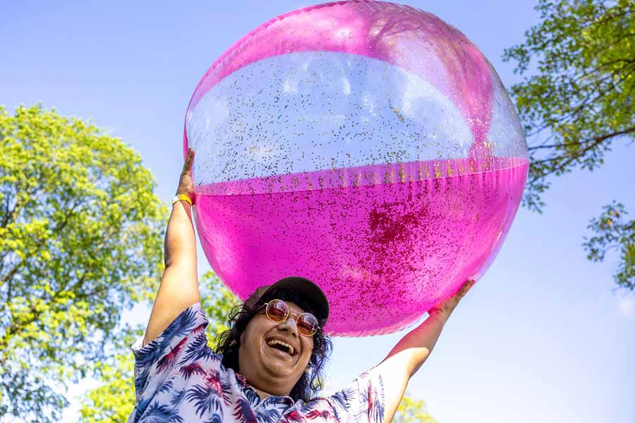 Student holding a pink balloon