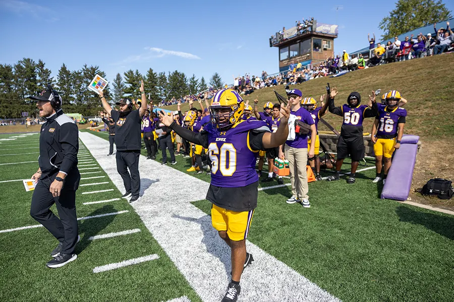 Members of the Knox College football team celebrate a touchdown during Saturday's game.