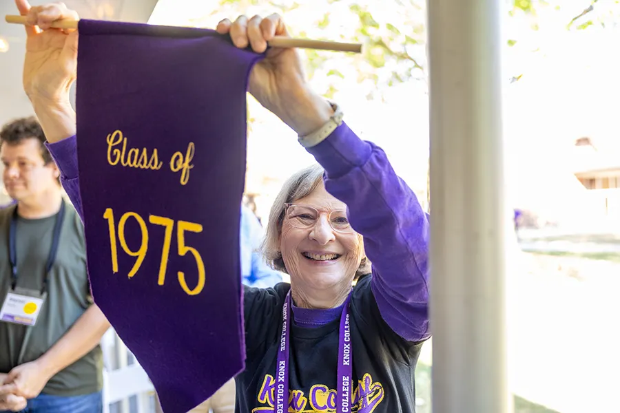 The 1975 banner leads the way at the Homecoming Convocation procession.