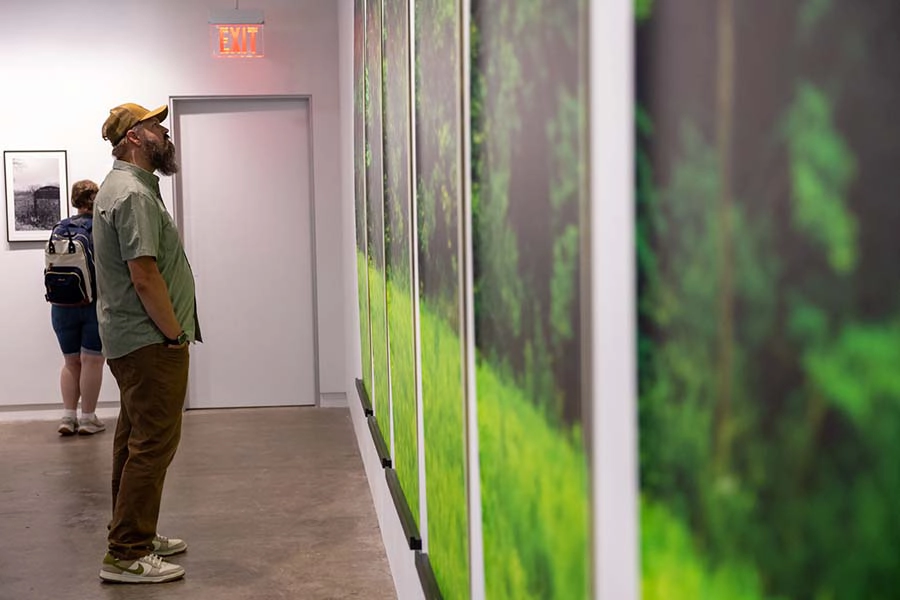 A student reviews the gallery at re:GeneratedPrairie showcase