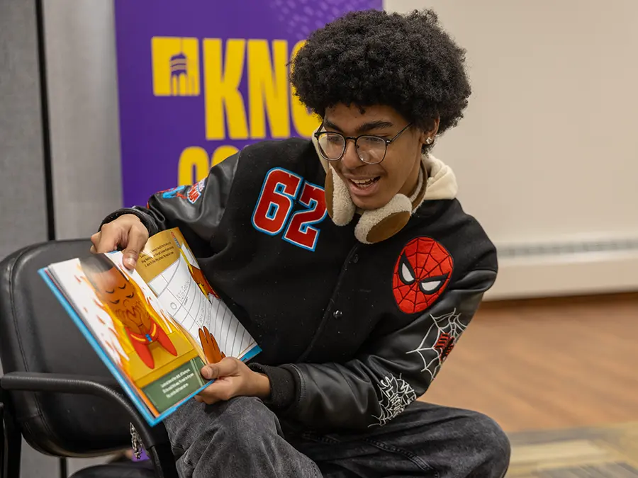 A member of Knox College A.B.L.E. (Allied Blacks for Liberty and Equality) participates in a Children’s Reading Hour at the Galesburg Public Library. 