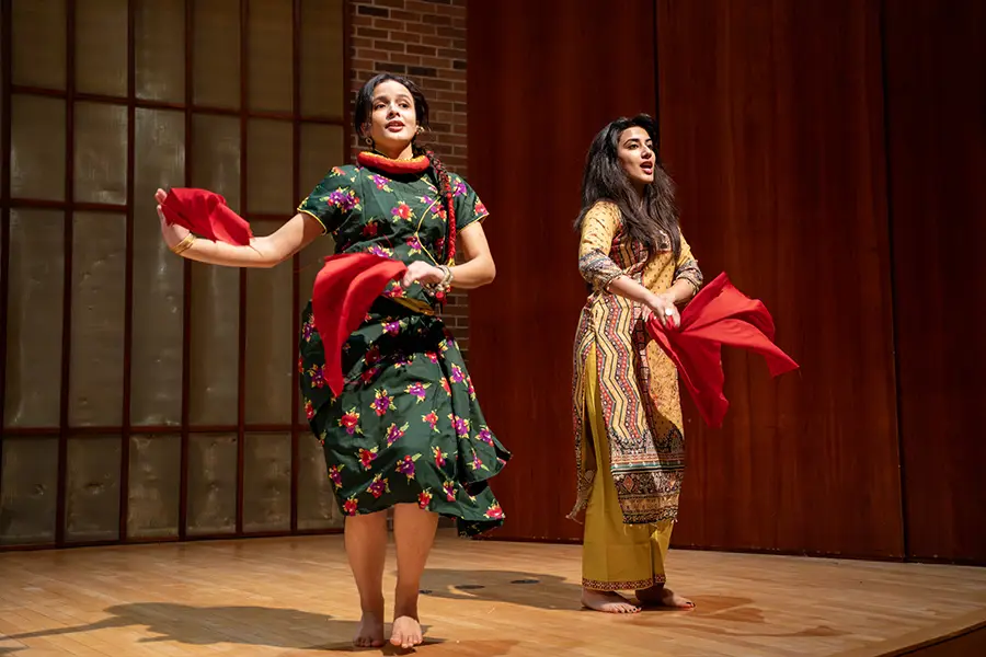Two Knox students dance on stage.