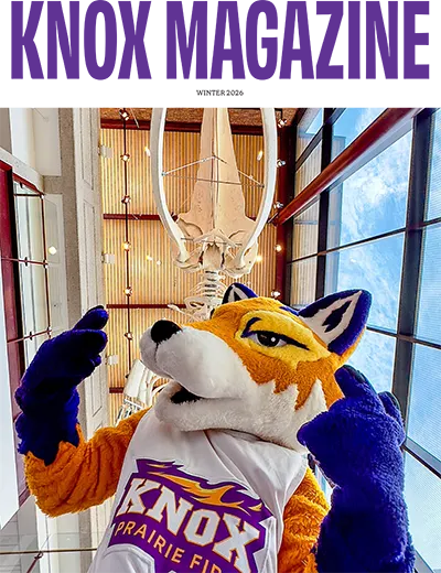 Knox Magazine Cover for the Winter '26 issue shows Blaze posing below a suspended whale skeleton in the Umbeck Science-Math Center. 
