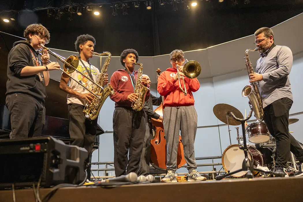 Members of the Galesburg High Band perform with Doug Stone