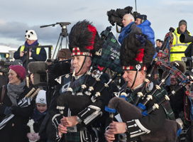 Mike Godsil's photo of bagpipe players and press