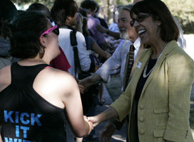 President Teresa Amott greets student