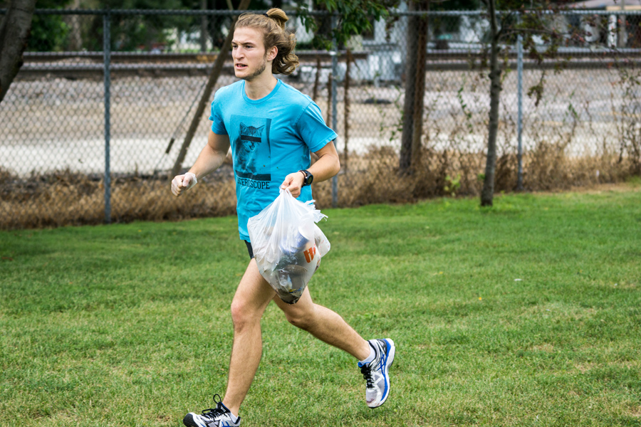Knox College cross country team member Josh Tvrdy, collecting trash on a preseason run.