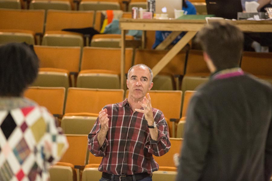 Director Neil Blackadder and Knox College students in rehearsal for The Island of Slaves by Pierre Marivaux.