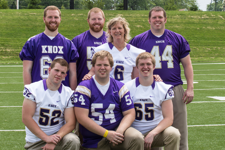 The six Paul brothers with mother Cindy Paul, on the football field at Knox College.