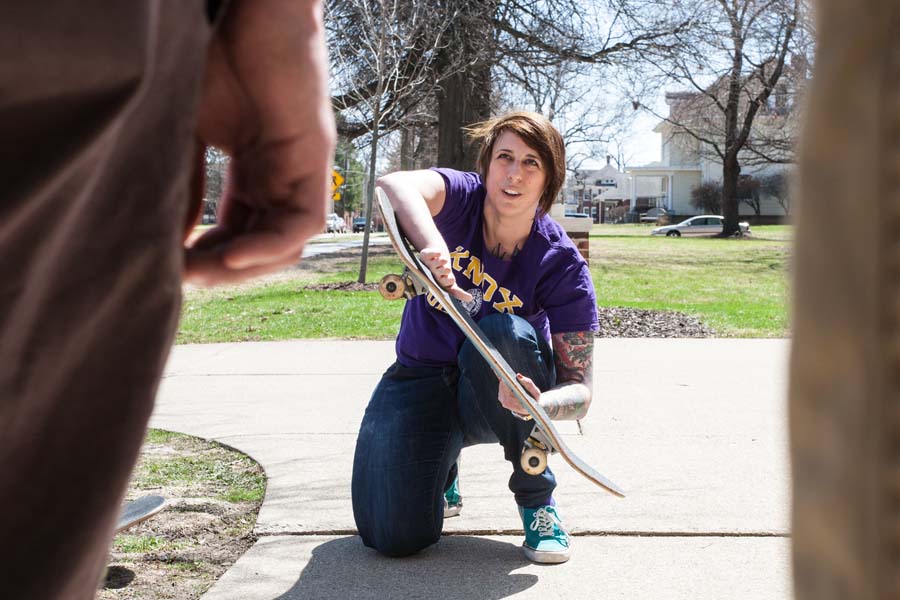 Physics professor Nathalie Haurberg explains forces involved in skateboarding to class in mechanics.