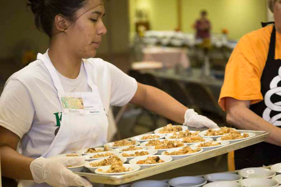 KnoxCorps Associate Shresha Karmacharya works at a Knox Prairie Community Kitchen community dinner.