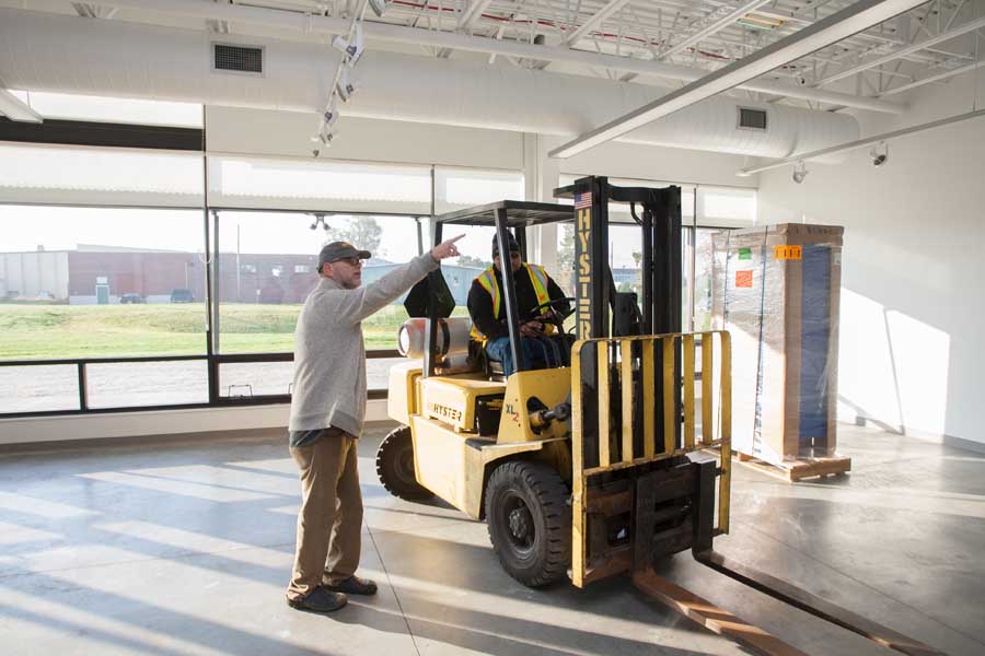 Knox College officials take delivery of equipment donated by Blick Art Materials for the new Whitcomb Art Center.