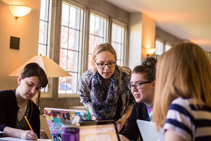 Knox College history students conduct research in Seymour Library for an exhibit on the history of Captain America.