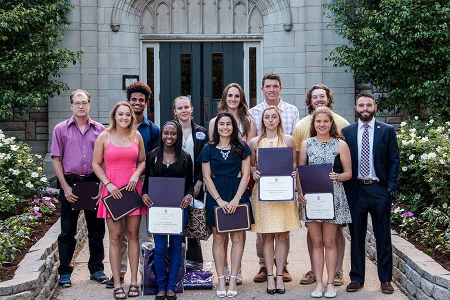 Students smile together after receiving awards at the 2017 Athletic Awards Banquet.