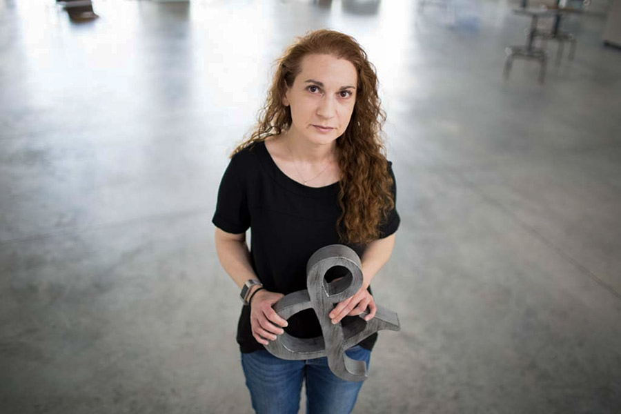 Professor of English Monica Berlin poses with an ampersand that her son Eli gave her.