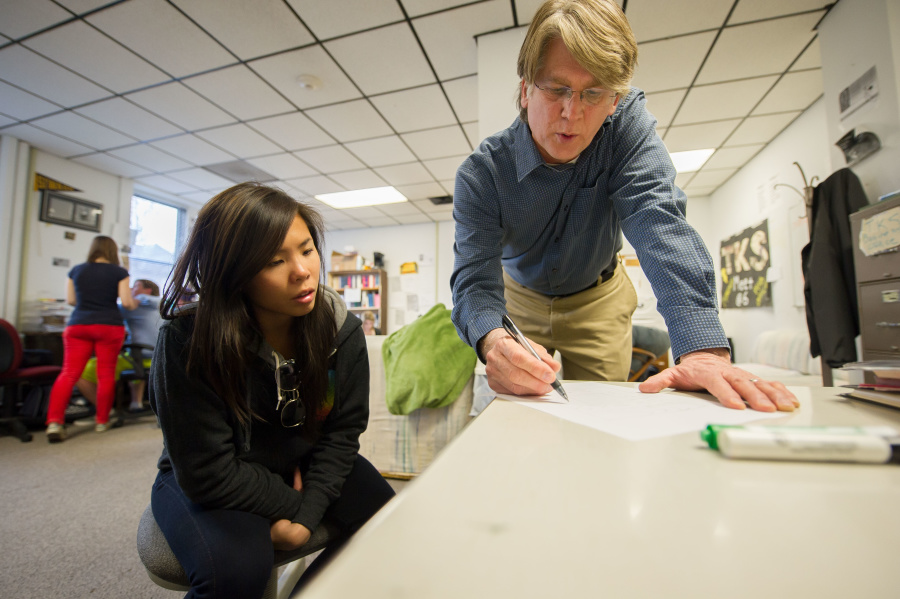 Advisor Tom Martin (left) and editor Erika Riley (right) talking to newspaper staff at organizational meeting for TKS, The Knox Student.