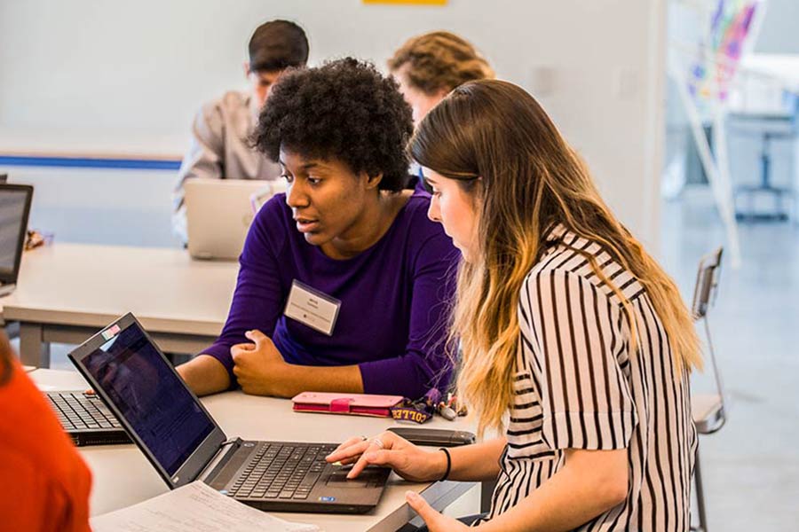 Knox College students working on a project in a business program.