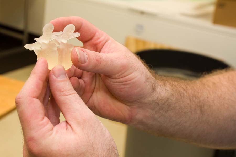 Biology Professor Nichlas Gidmark with piece created on 3D printer.