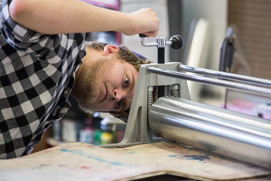 Knox student Carl Voss working in the print studio.