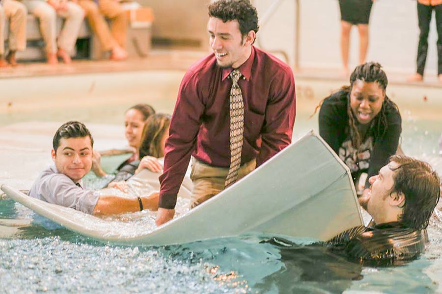 Students in psychology class Organizational Behavior with faculty Frank McAndrew, engage in team-building games in swimming pool.