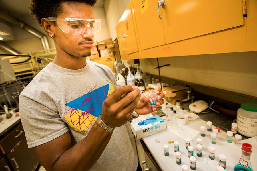 Student Malik Hamilton working in chemistry research lab, on faculty Tom Clayton's project on liquid crystals.