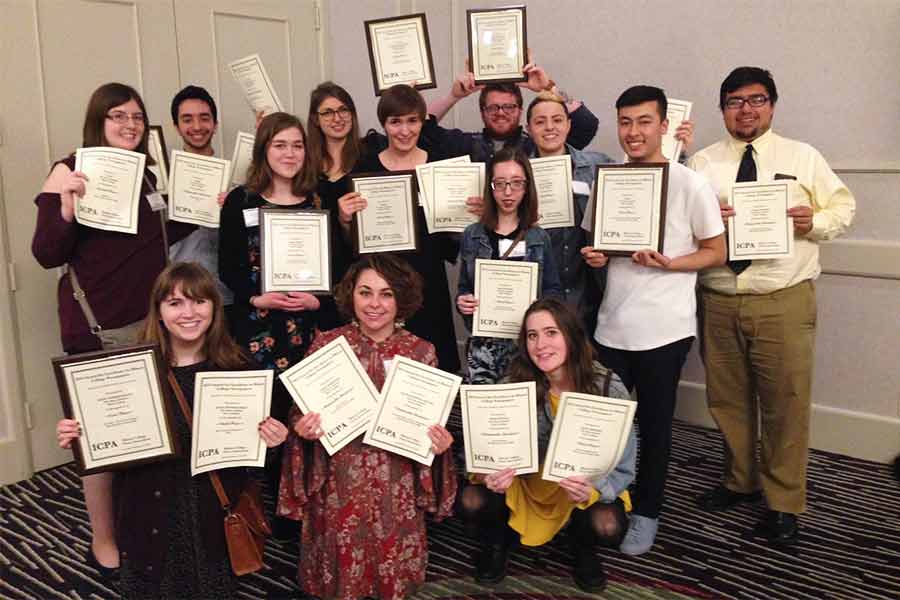 The staff of "The Knox Student" holds up a record-breaking 20 awards at the most recent ICPA conference. 