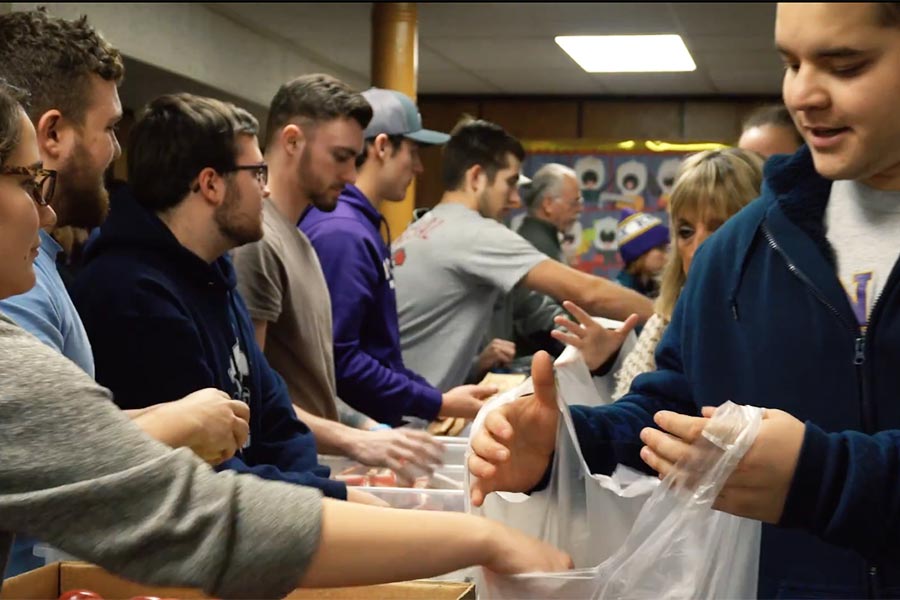 Knox College students bag food for elementary age children.