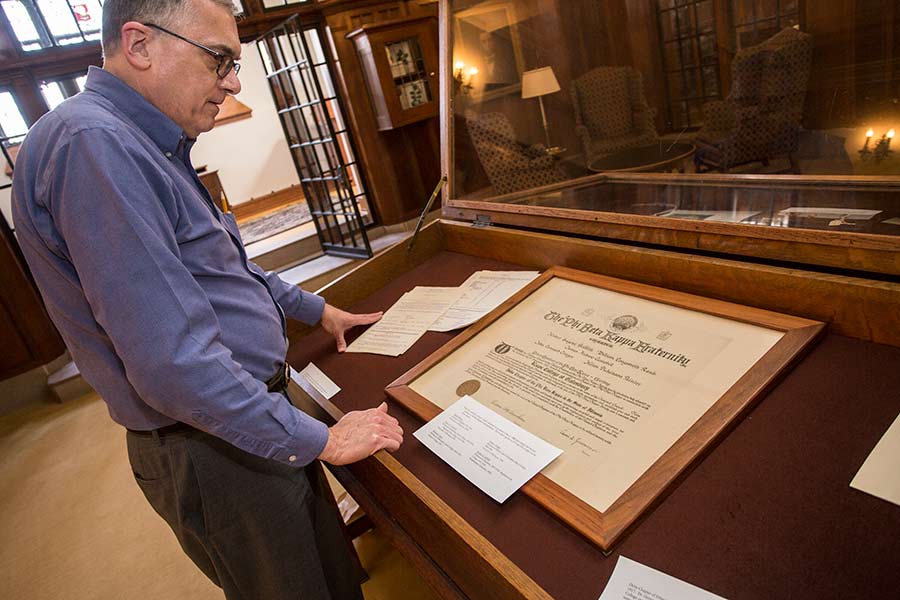 Knox librarians prepare a display of archived items in Seymour Library. 
