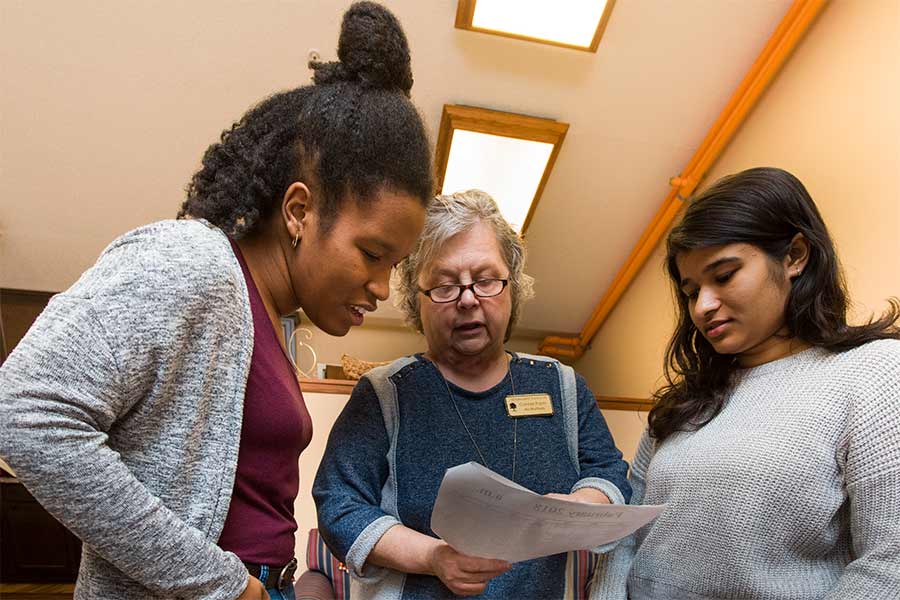 Students Avantika Gupta and  Aliya Estes (right) confer with Connie Pople, activities director at Seminary Manor and supervisor of their experience during Clinical Psychology Term.