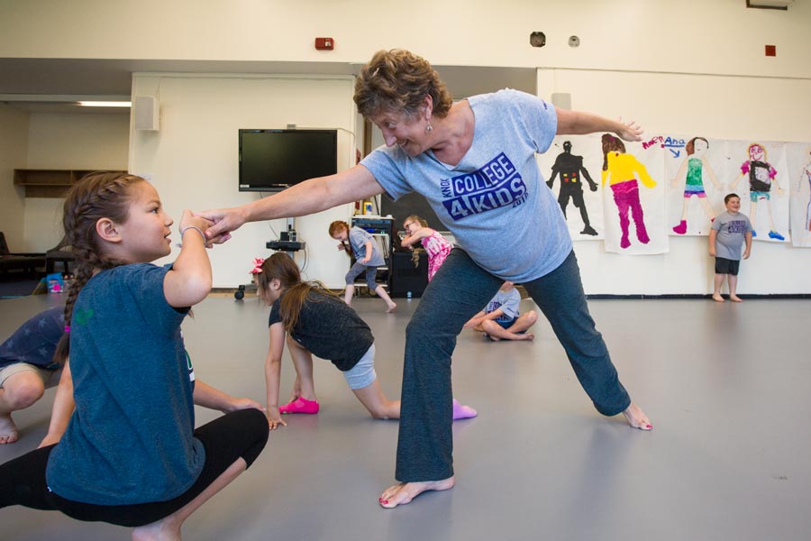 Kathleen Ridlon, director of the Kleine Center for Community Service, leads a dance lesson with the Junior Program of College for Kids. 