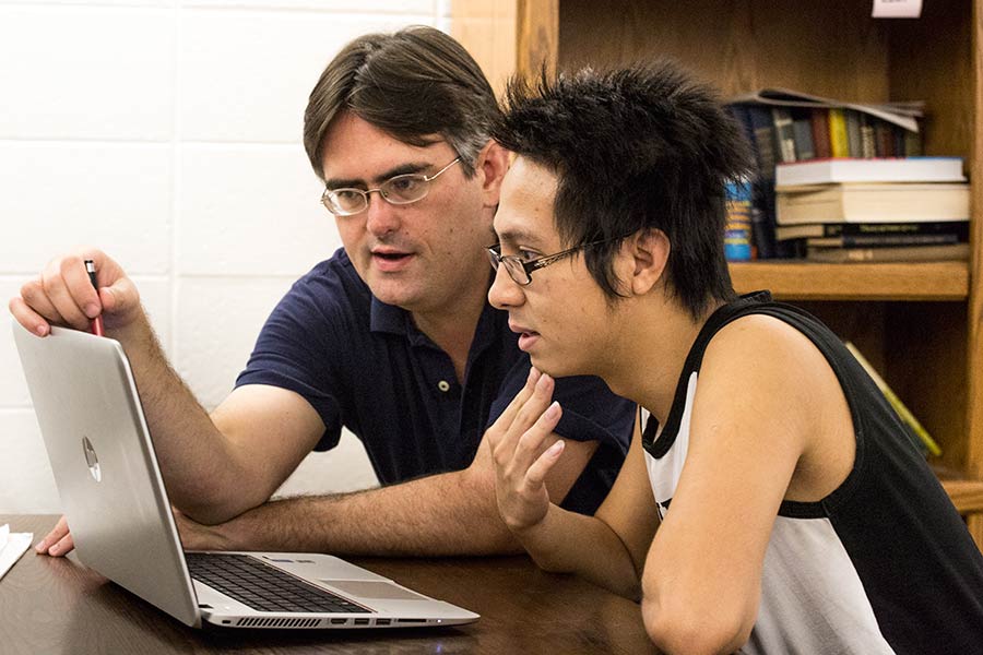 Professor Bunde works with a computer science student.
