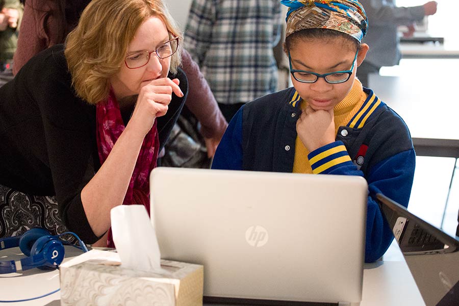 Professor Monica McGill works with a student on her project.