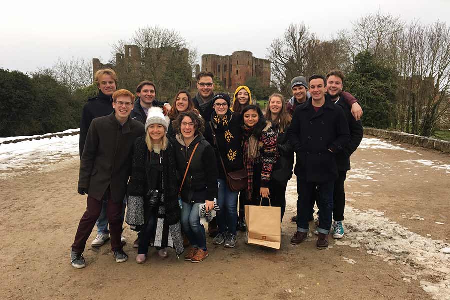 Students in Knox's London Arts Alive program smile in front of castle ruins in London, England.