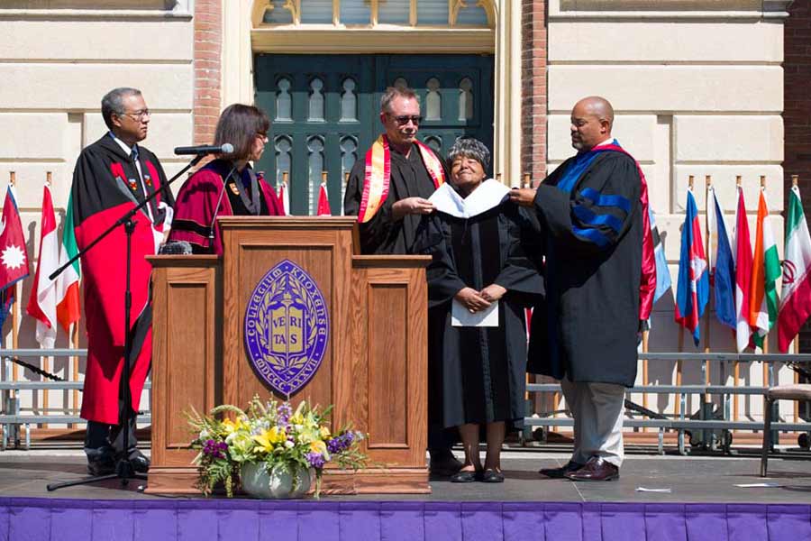 As part of Opening Convocation 2018, President Teresa Amott confers an honorary degree on Elizabeth Eckford ‘63, who presented the Convocation Address.