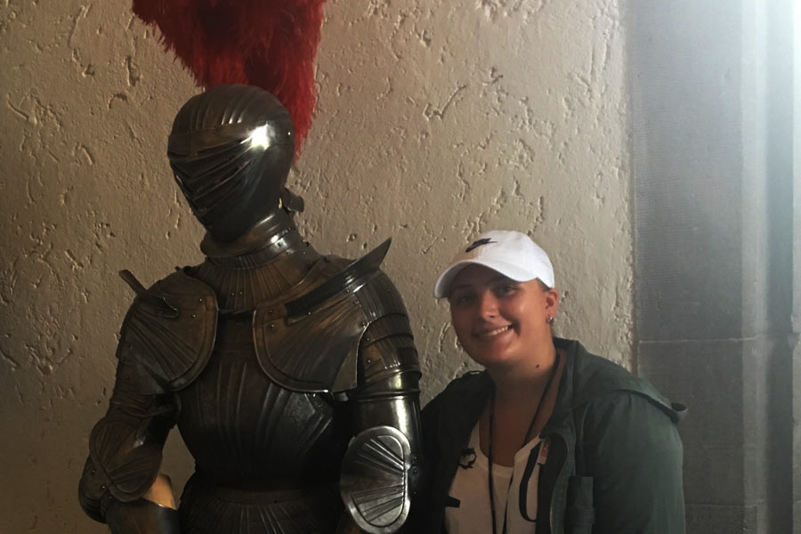 Sarah poses with suit of armor while touring castle in Germany. 