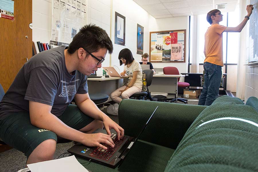 Students work on computer science research for Knox College Computer Associate Professor David Bunde.