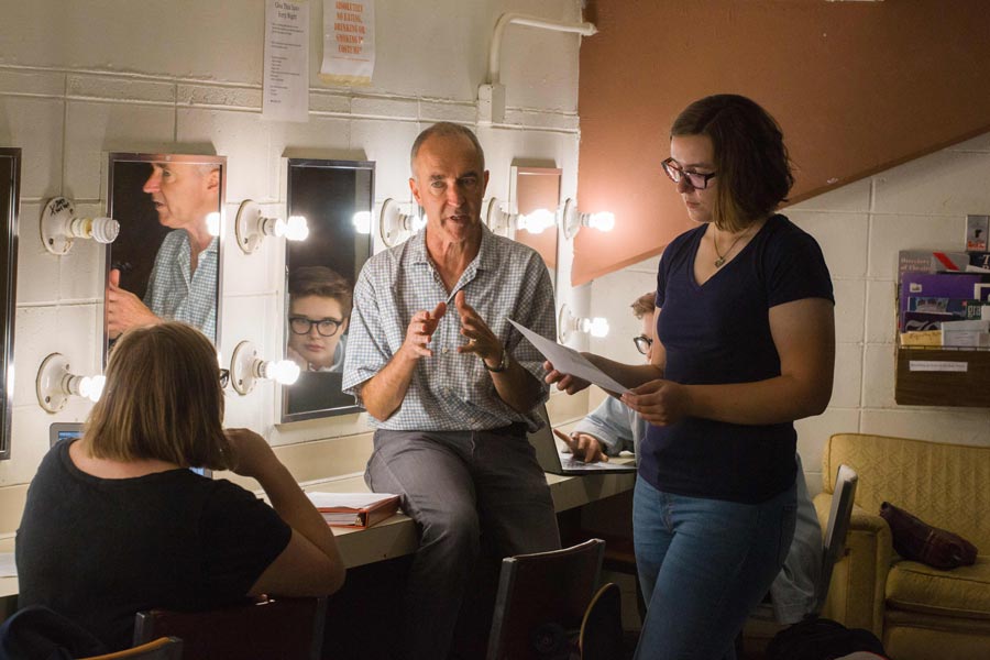 Blackadder engaging with students during rehearsal.