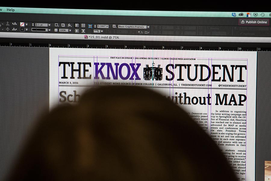A student lays out an issue of The Knox Student